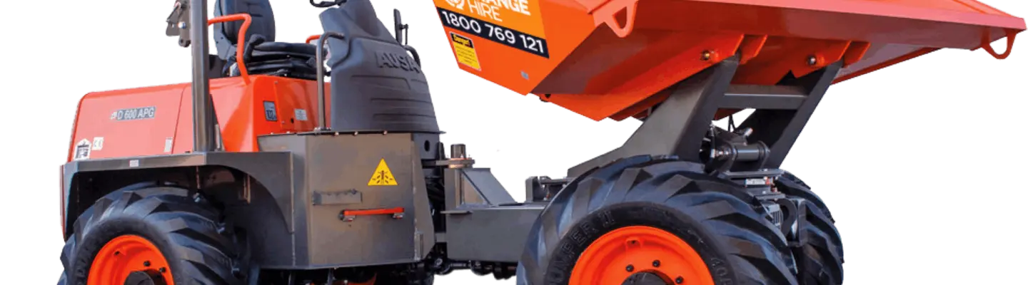 Site dumper positioned on a construction site, used for transporting materials with safety barriers in the background.