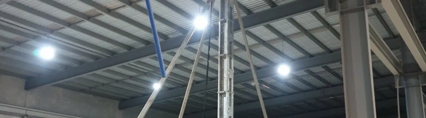 Construction site near building with support props and temporary tracks set up for structural stability and access.
