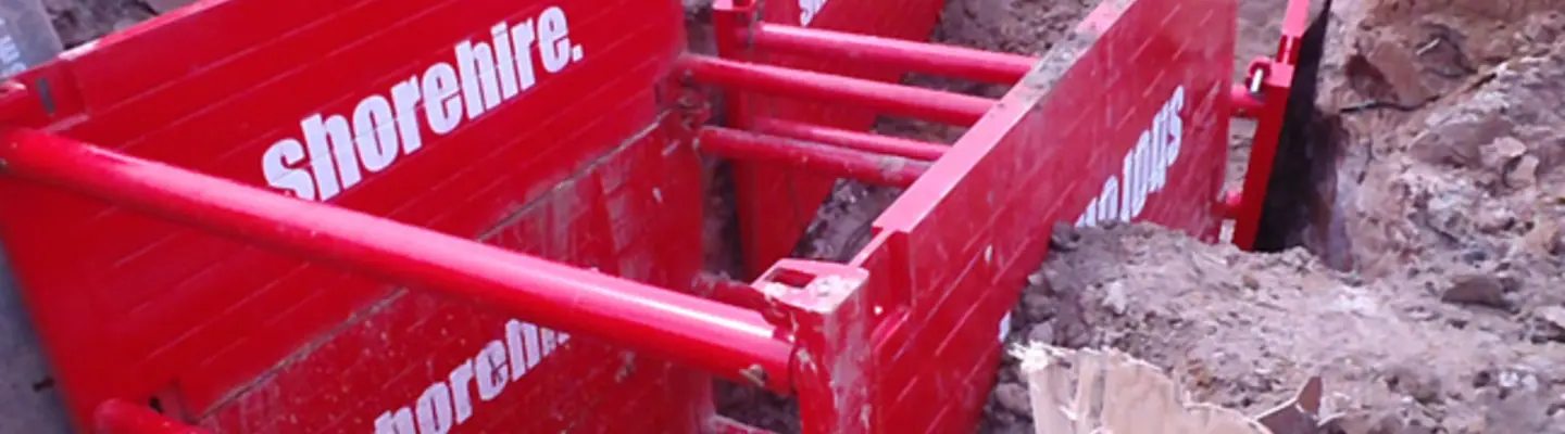 Shoring box installed in excavation site to stabilize trench walls during underground utility work.