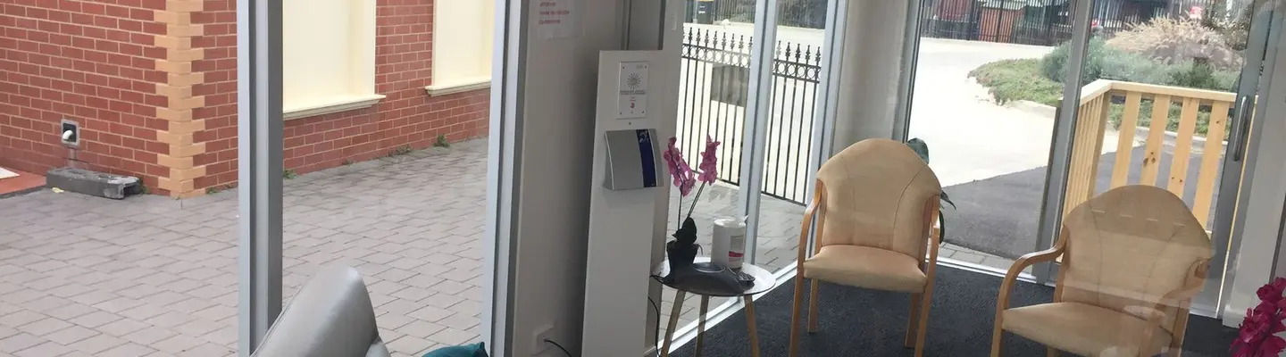 Cozy interior of a shipping container pod with seating and decor, showcasing innovative and compact visitor space design.