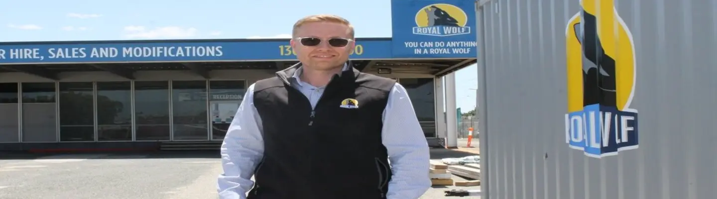 Company manager standing in front of the company building, overseeing operations related to construction safety and barrier solutions.