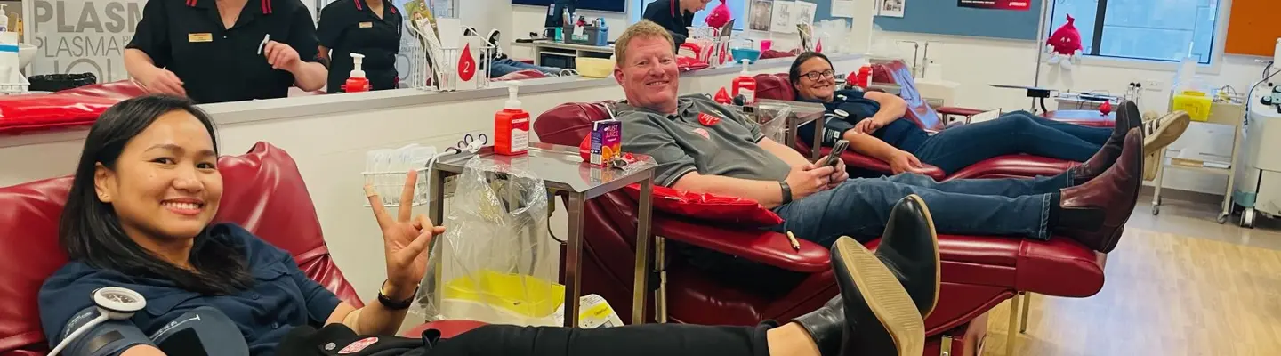 Company staff members participating in a blood donation drive, highlighting employee involvement in community health efforts.