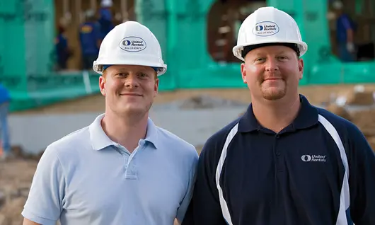 two men in hard hats on construction site