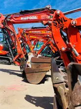 An excavator at a construction site, digging and moving earth as part of site preparation and infrastructure development.