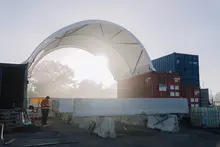 A man using leveling bars to measure and ensure even ground surface at a construction site for accurate grading.
