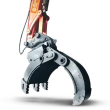 Close-up of a rock grab attachment mounted on heavy machinery, designed for handling large rocks at construction sites.