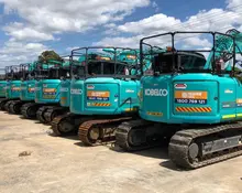 Multiple excavators lined up at a construction site, representing Orange Hire’s fleet for earthmoving and barrier projects.