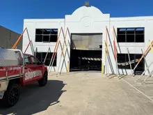 Aluminium and steel tilt props installed inside a building to provide temporary structural support during construction.    